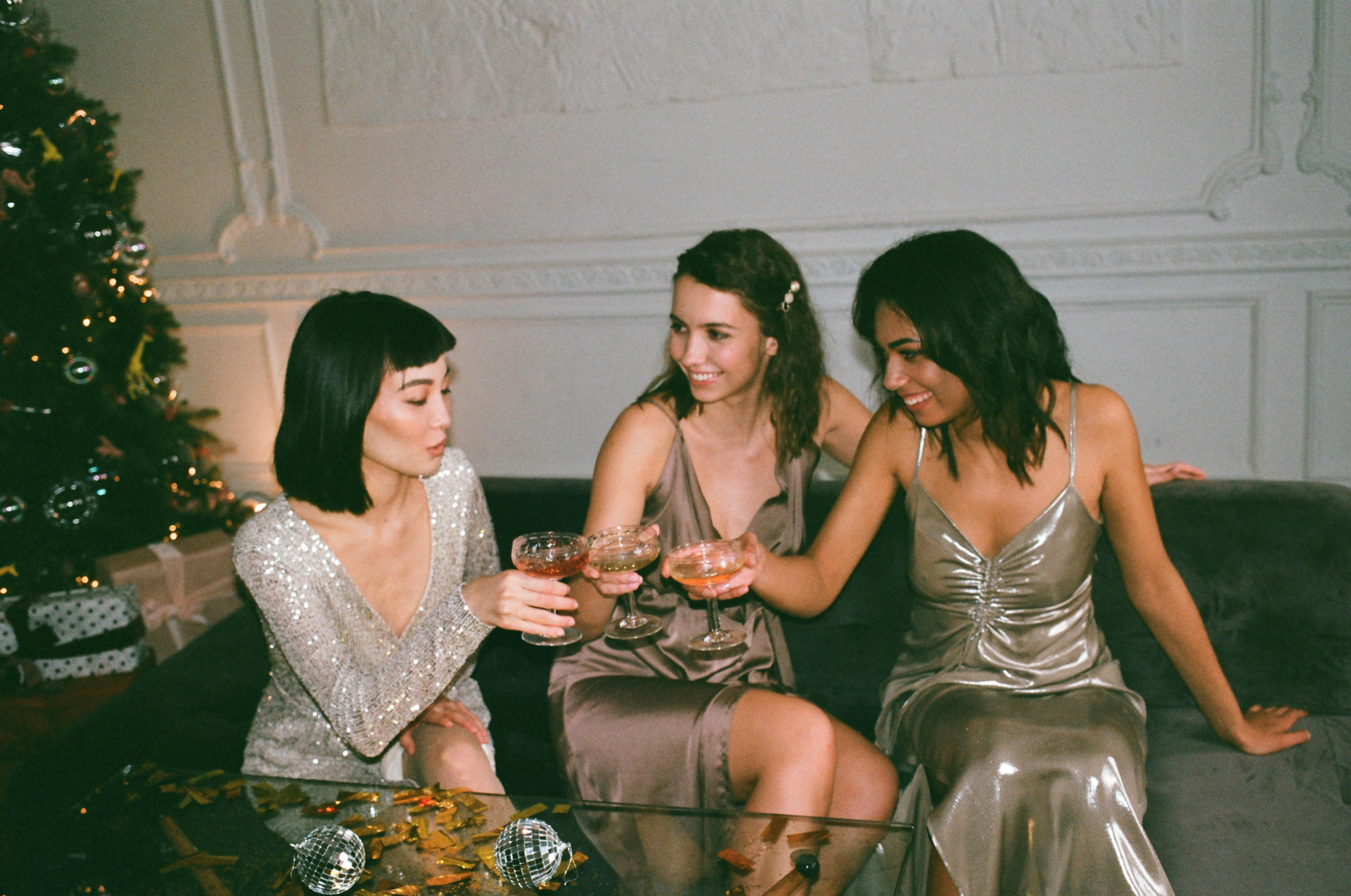 three women sitting on a sofa