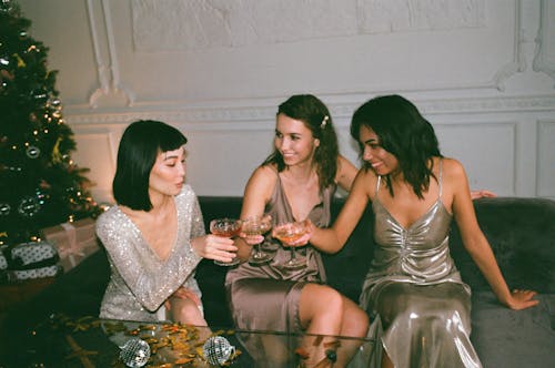 Three Women Sitting on a Sofa