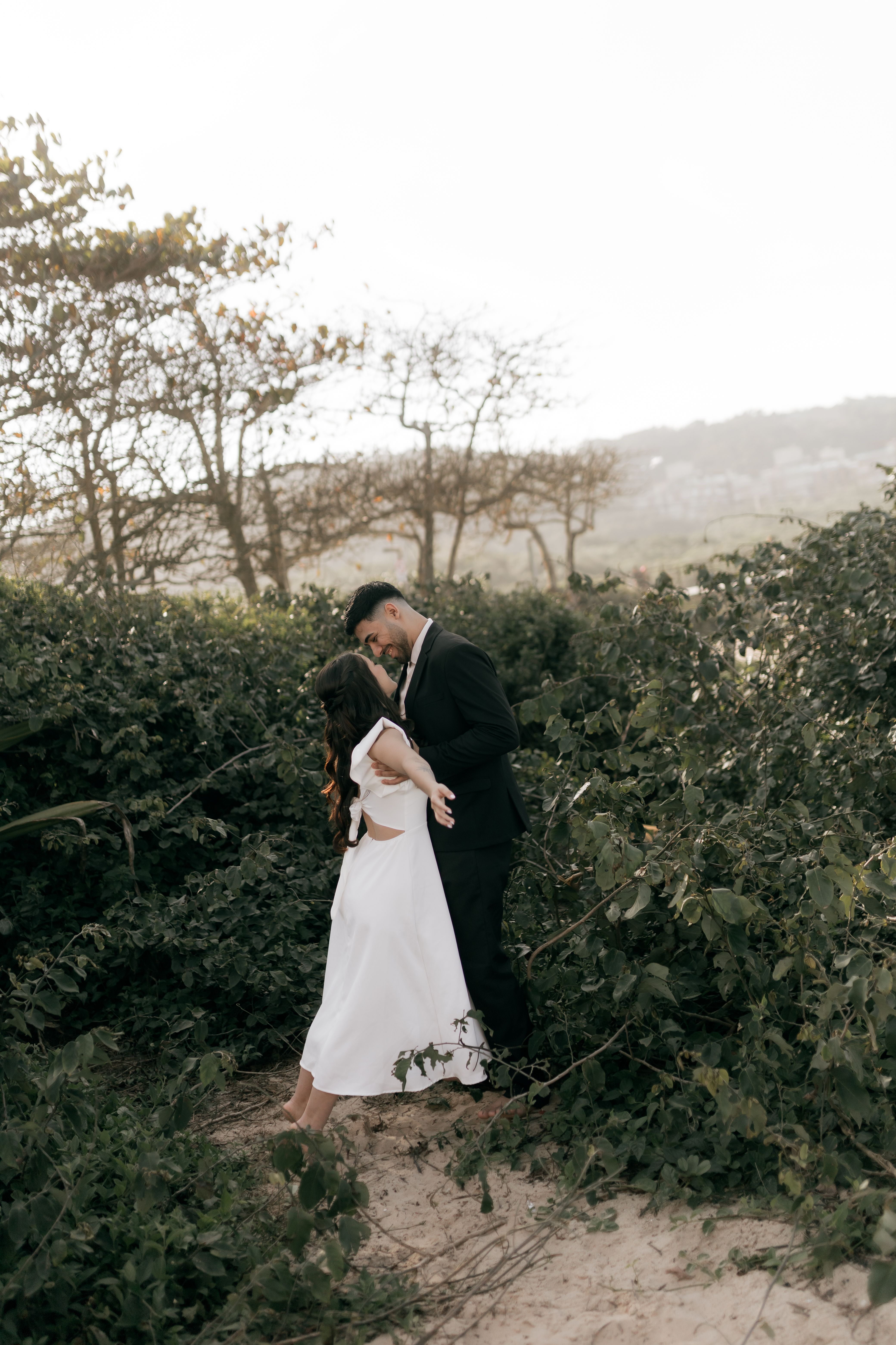 Romantic Beach Wedding Couple Embracing Outdoors · Free Stock Photo
