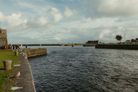 Peaceful river scene with cloudy skies in Galway, Ireland.