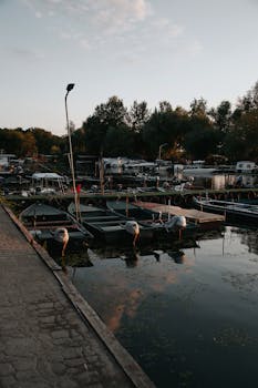 Peaceful evening view of a harbor in Hungary with boats and a tranquil atmosphere.