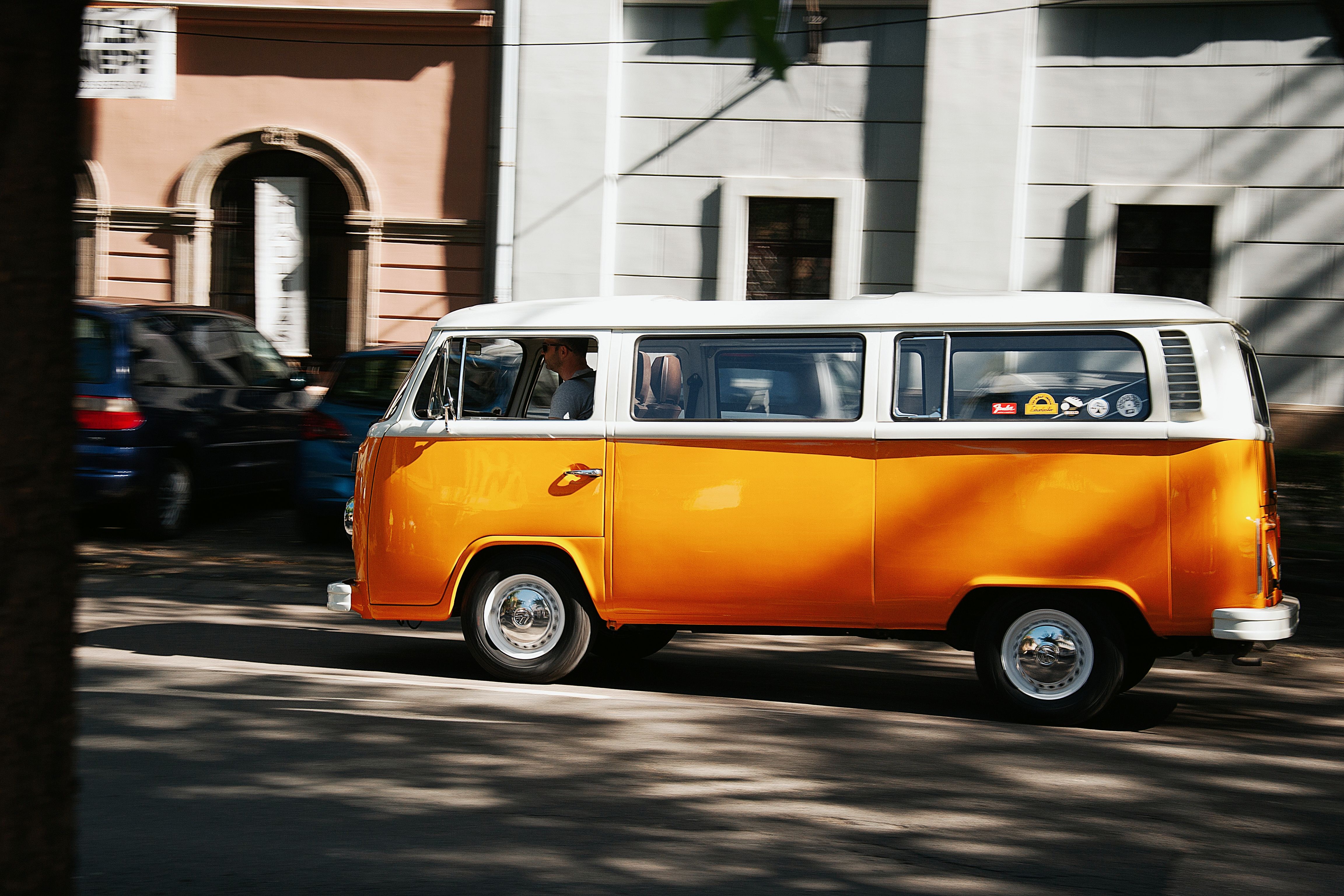 Vintage Yellow Van Driving in Urban Hungary · Free Stock Photo