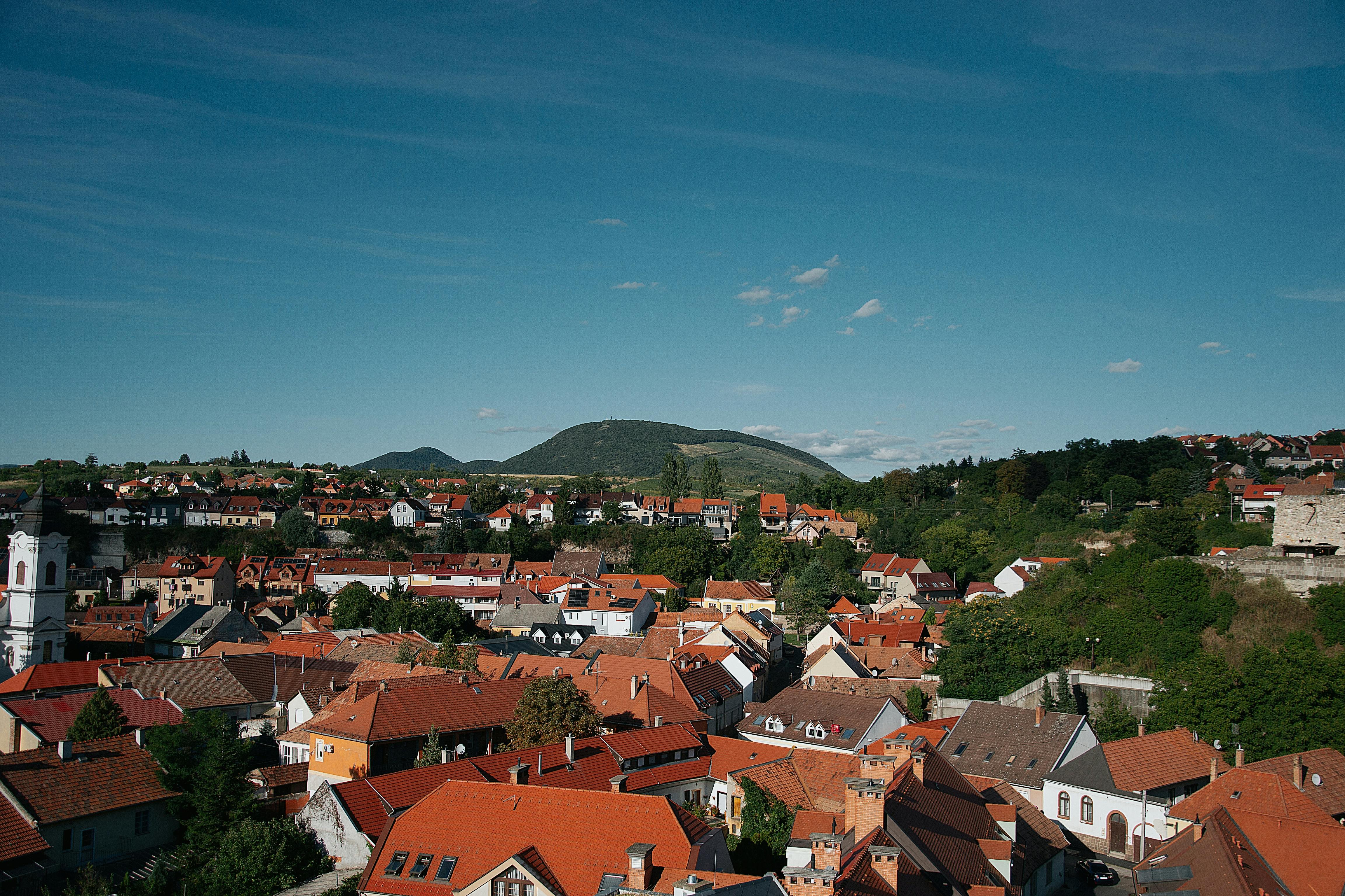 Aerial view of Ho town with green hills in the background and a clear blue sky