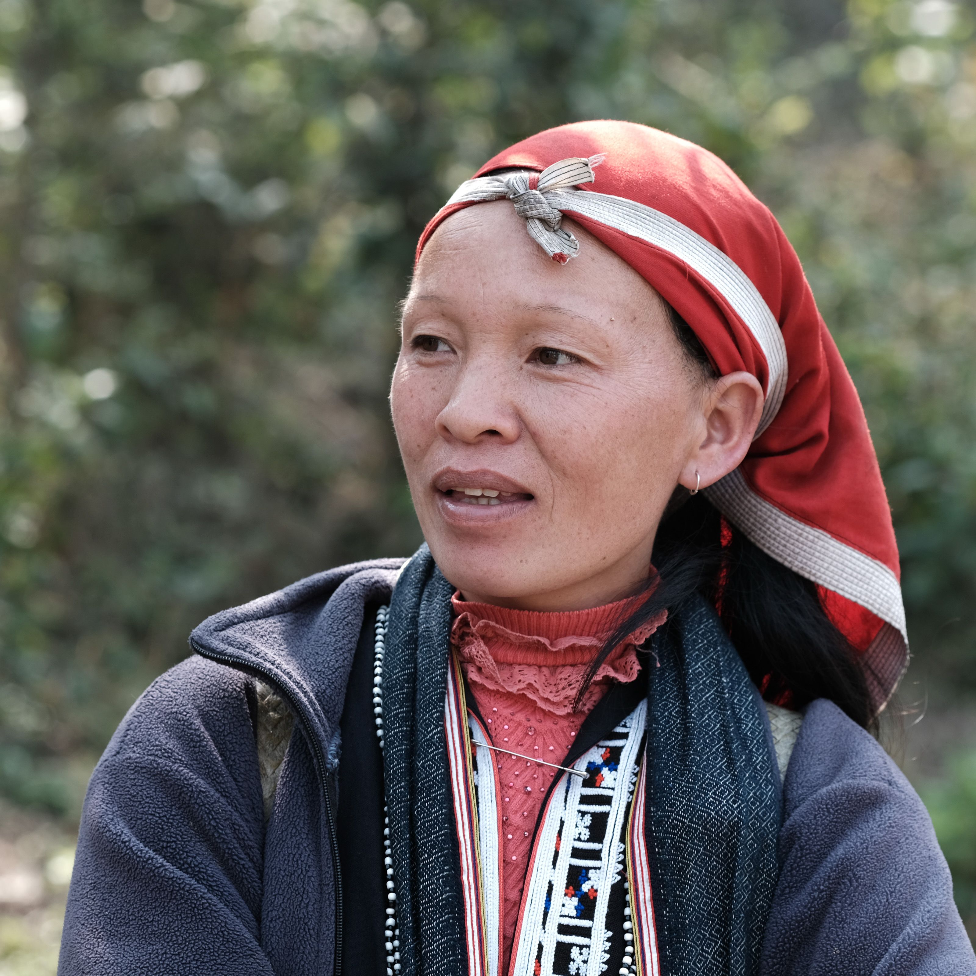 A woman in Lào Cai, Vietnam, wearing traditional attire, representing cultural heritage.