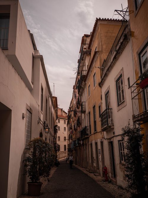 Free Explore a narrow, picturesque alley in a historic European town, ideal for travel lovers. Stock Photo