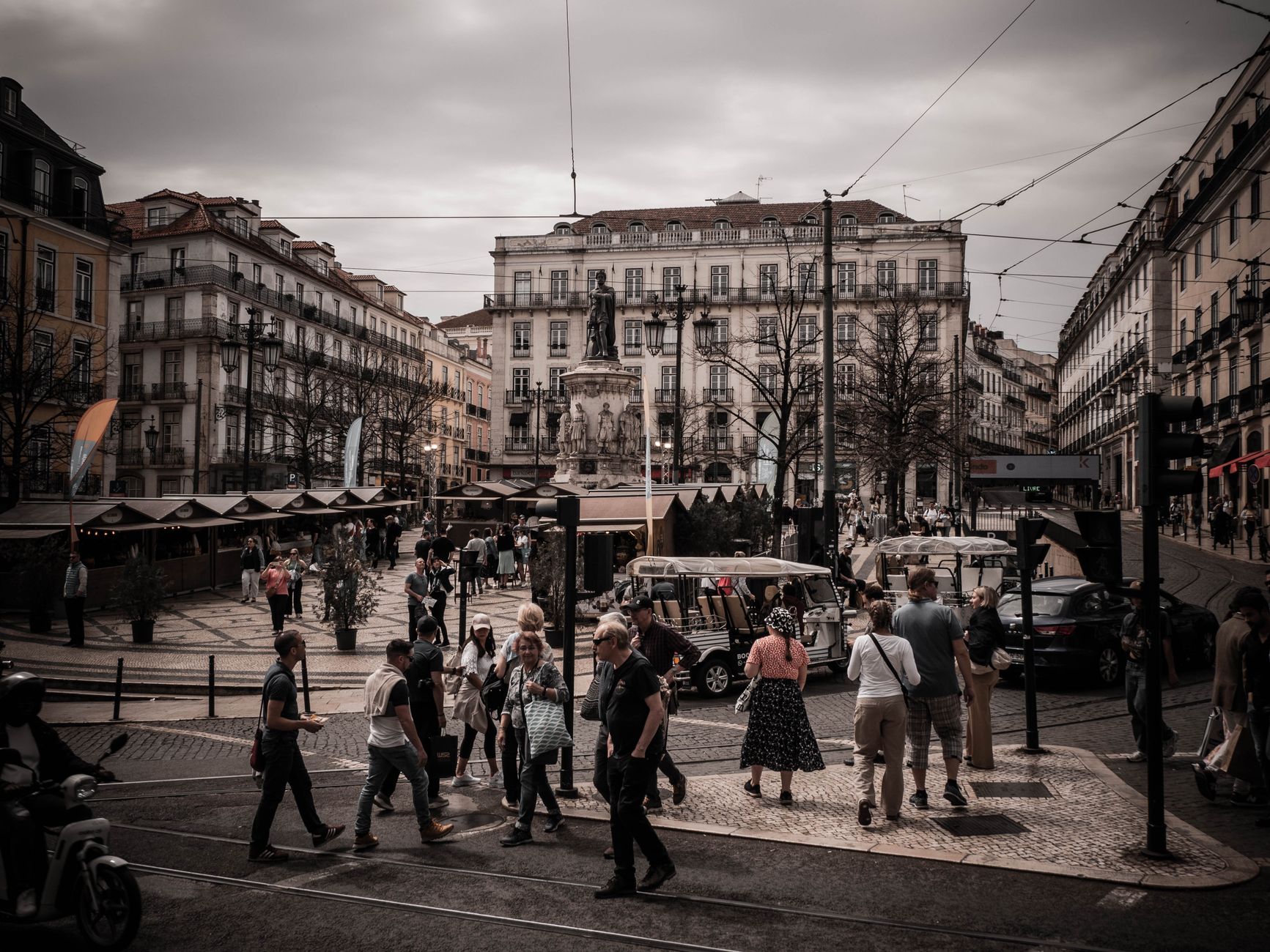 Crowded pedestrian area at Rossio Square with historic architecture in the heart of Lisbon.
