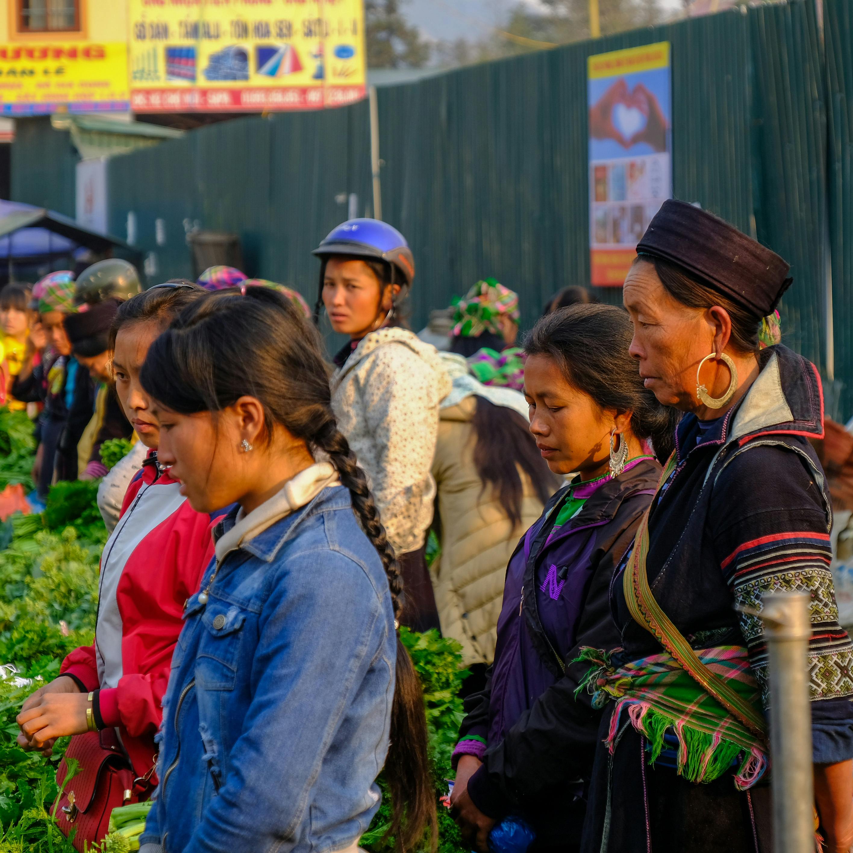 Colorful snapshot of diverse people at Lào Cai market in Vietnam.