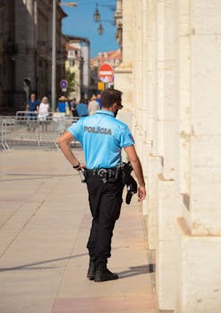 A police officer patrolling a sunny urban street, showcasing law enforcement presence.