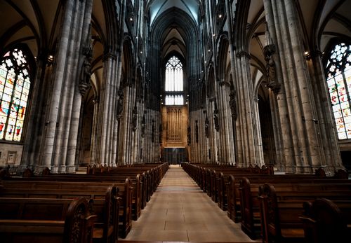 Free Stunning view of a Gothic cathedral's interior, highlighting the grand architecture and stained glass windows. Stock Photo
