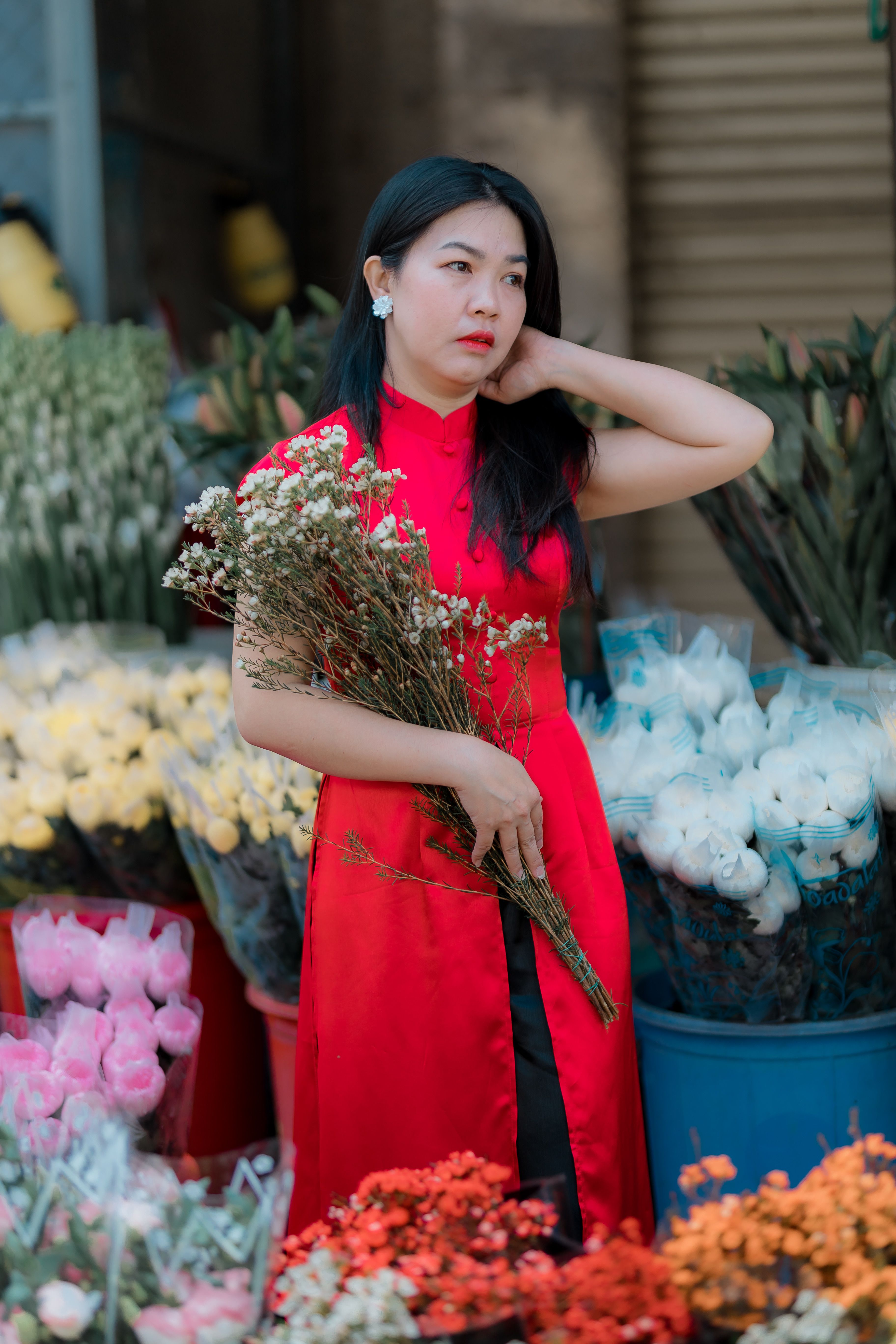 Woman in Red Dress Holding Flowers Outdoors · Free Stock Photo