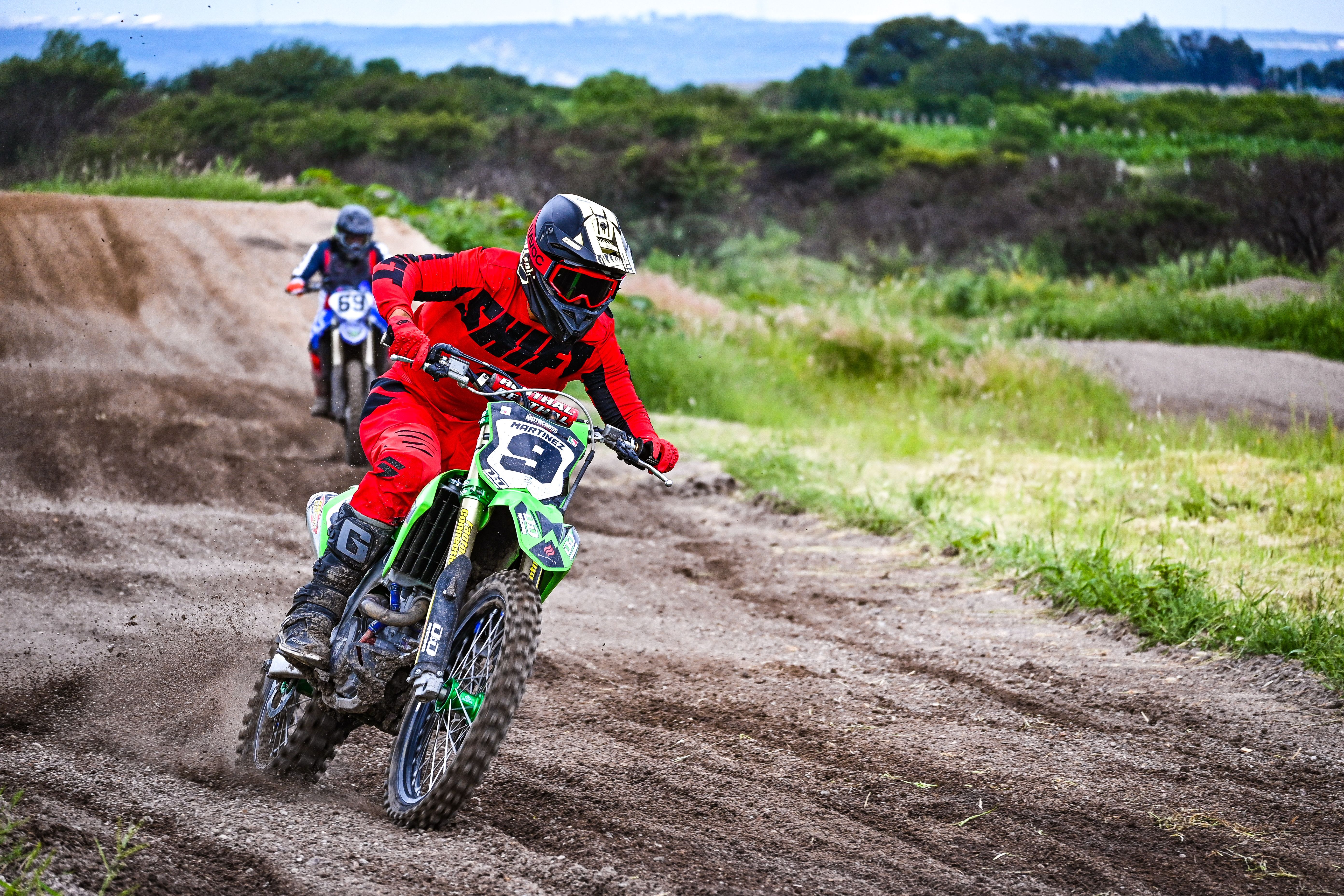 Motocross riders racing on a dirt track outdoors. Dynamic action shot capturing speed and adrenaline.