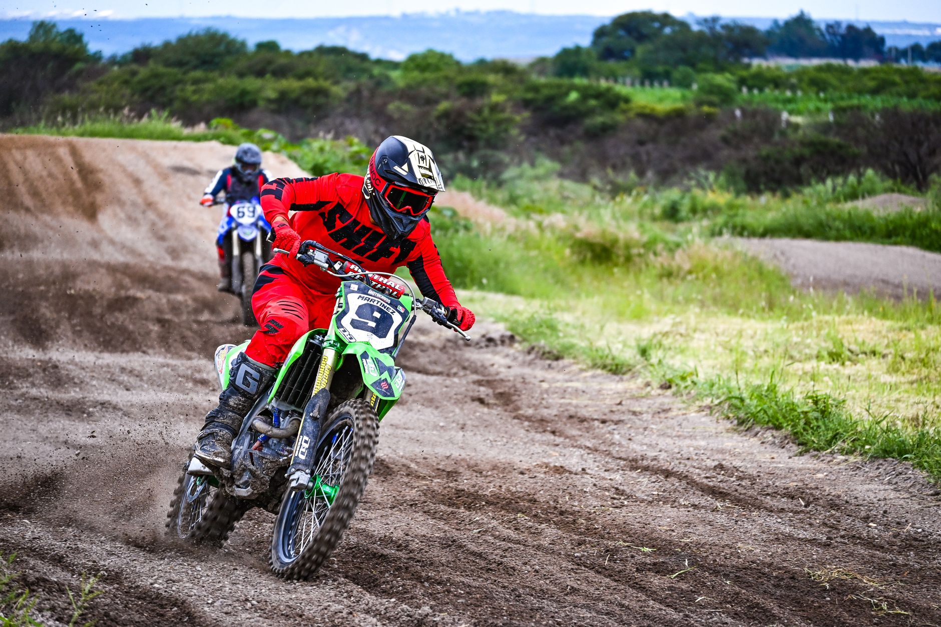 Motocross riders racing on a dirt track outdoors. Dynamic action shot capturing speed and adrenaline.