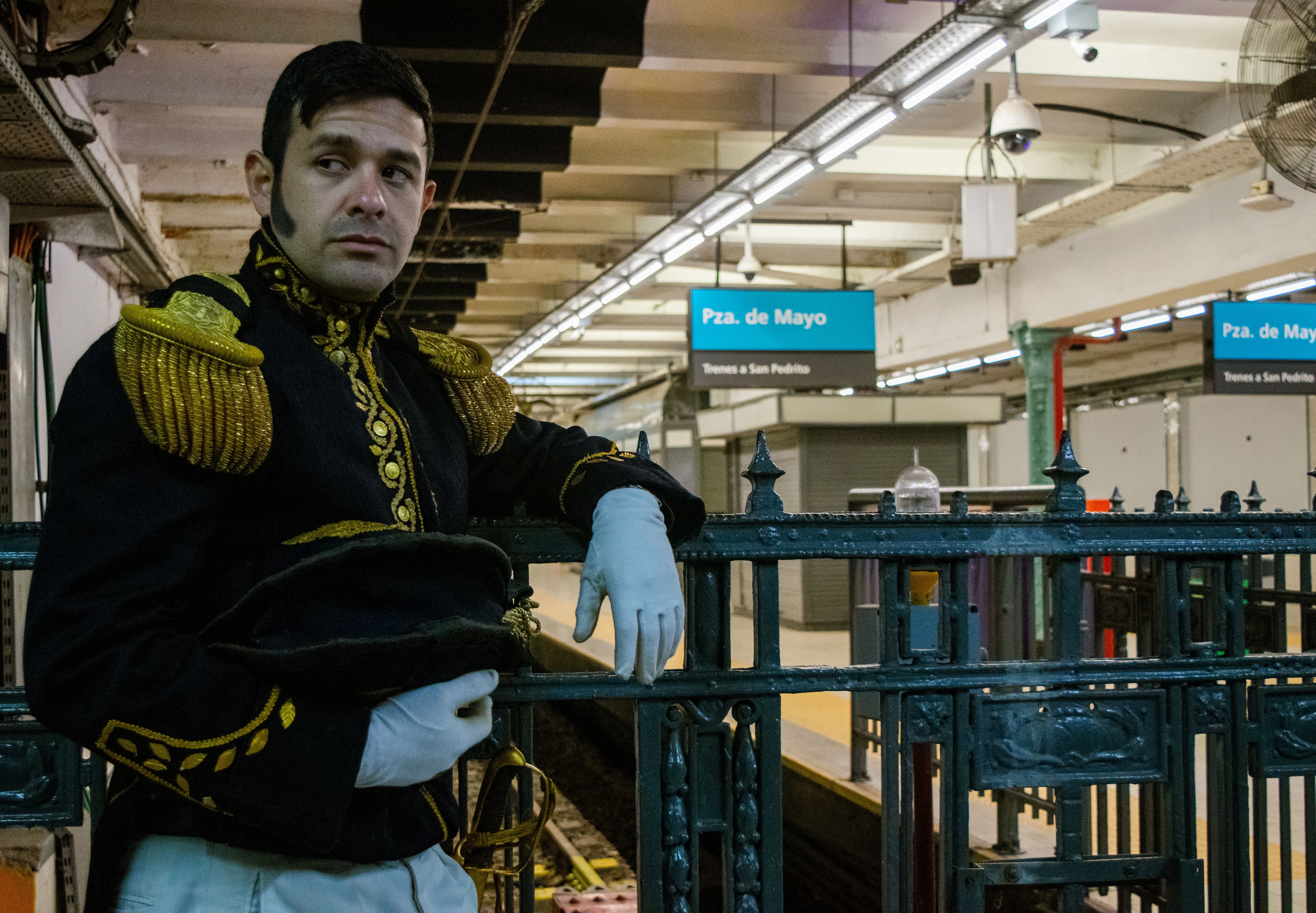 Person in traditional costume at Plaza de Mayo subway station in Buenos Aires.