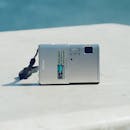 Compact Digital Camera on Marble Surface Outdoors