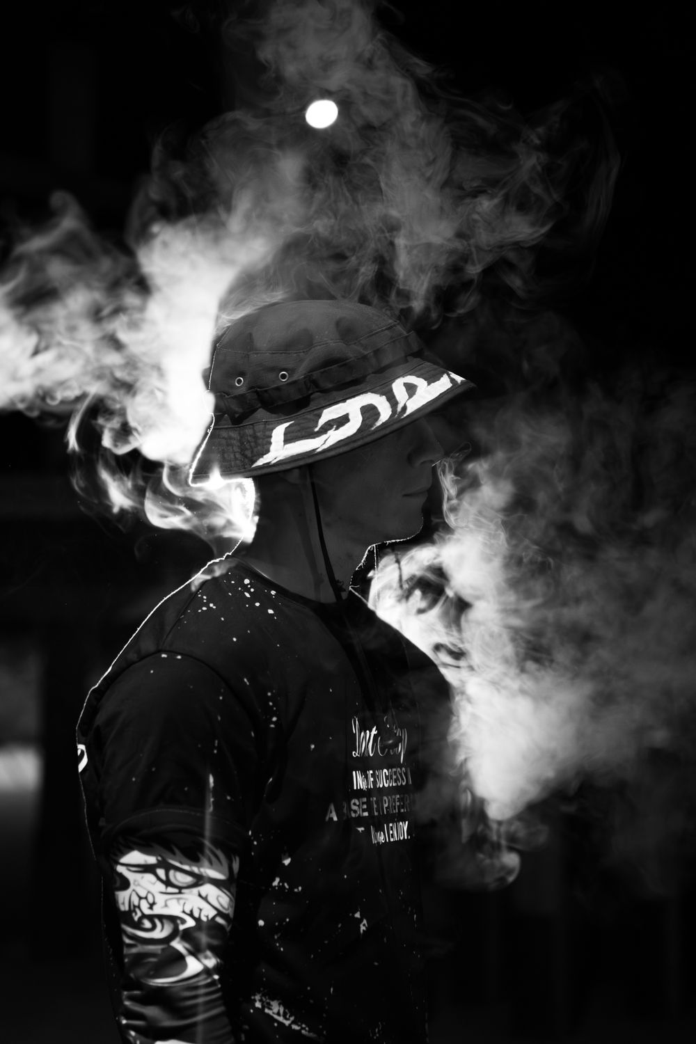 Moody portrait of a man wreathed in soft smoke