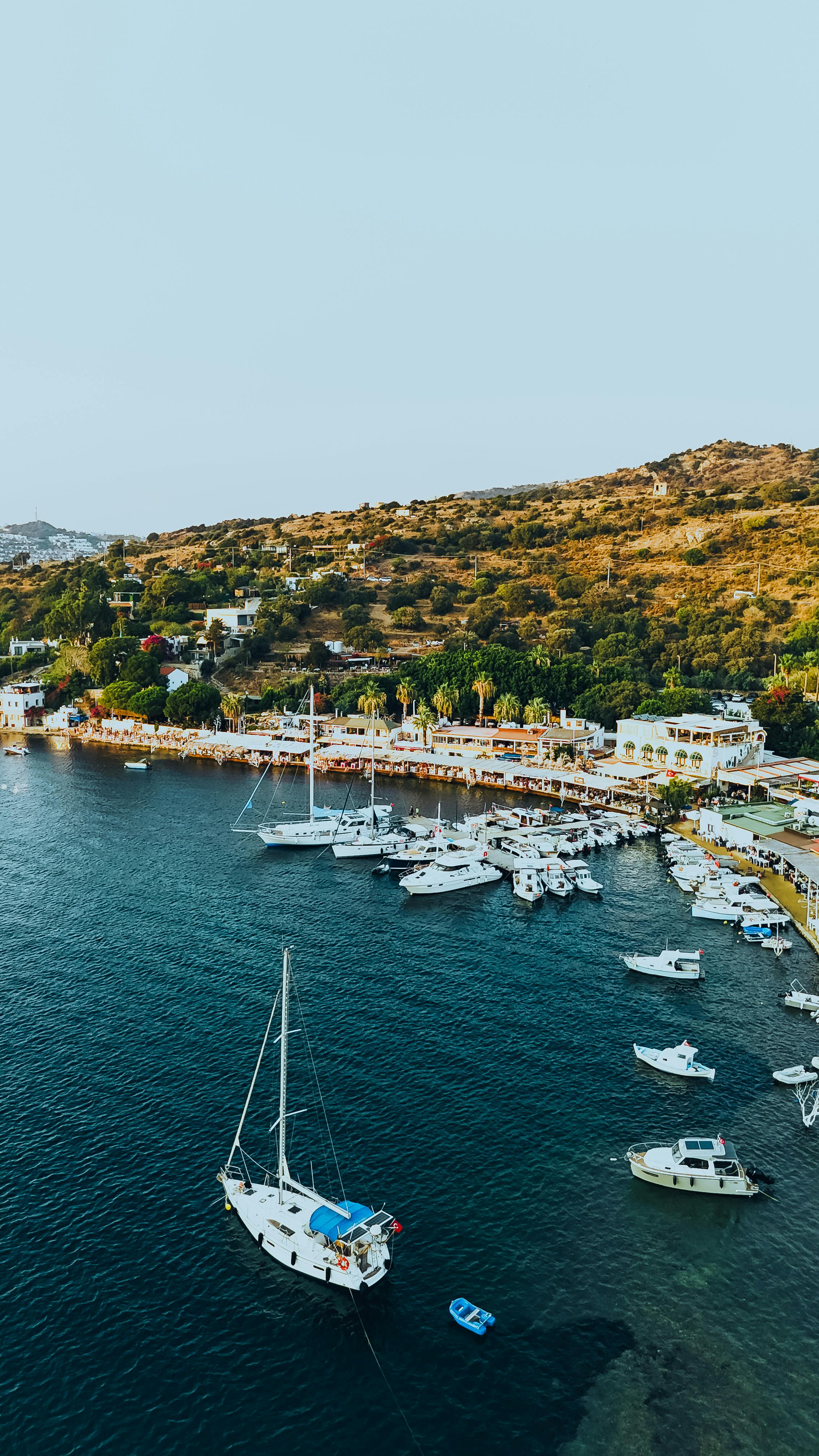 무료 그림 같은 지중해 해안선을 따라 있는 보트와 언덕을 공중에서 본 모습입니다. 스톡 사진