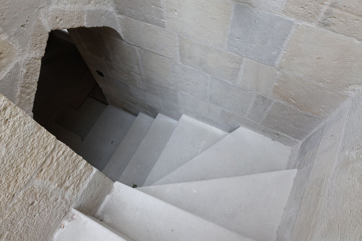 Steep narrow stone staircase inside historic Italian building with curved walls similar to Brunelleschi dome interior