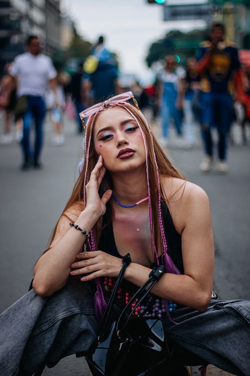 Free Stylish woman with braided hair poses in city street, exuding modern urban fashion vibes. Stock Photo