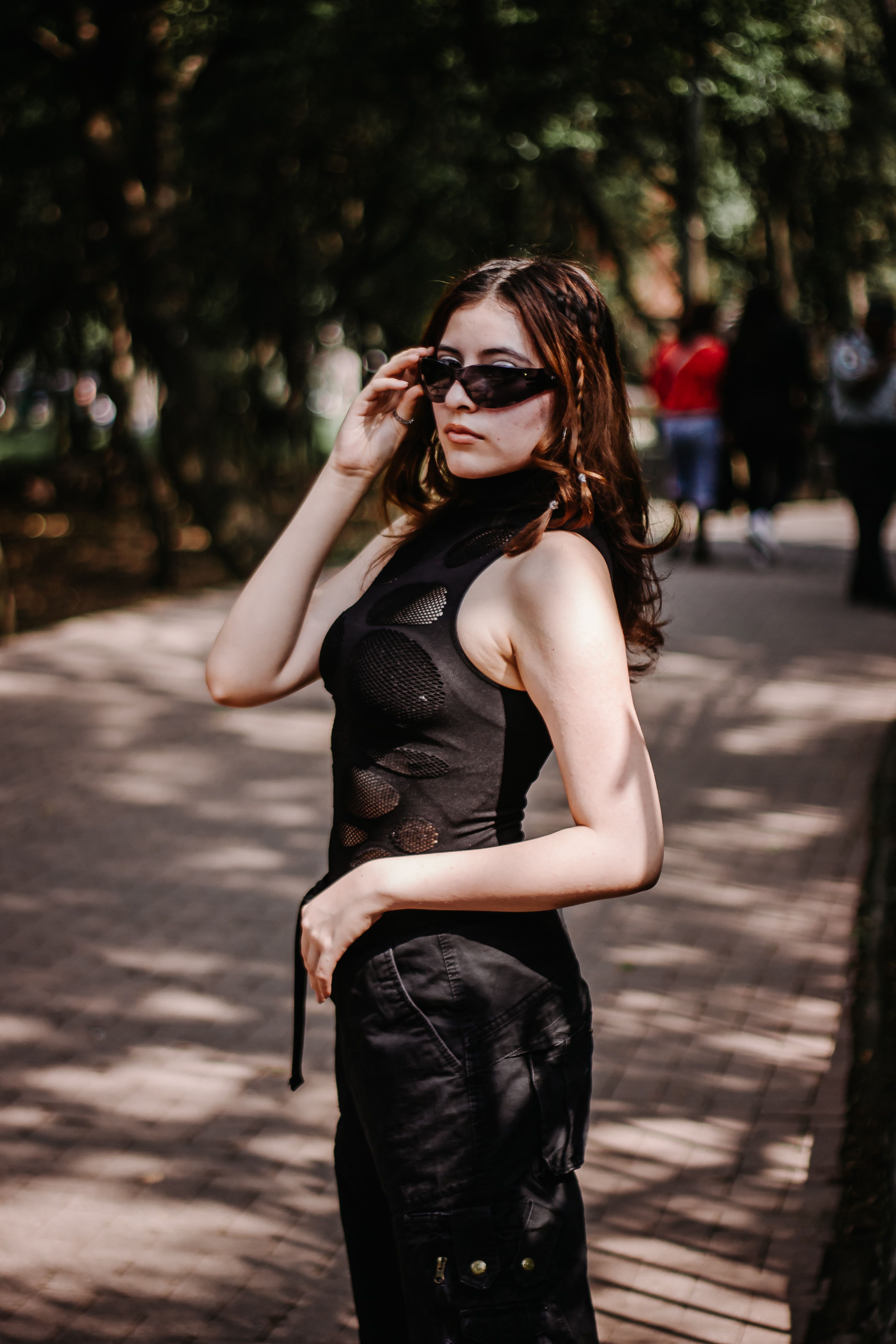 Stylish Woman Posing Outdoors in Sunglasses · Free Stock Photo