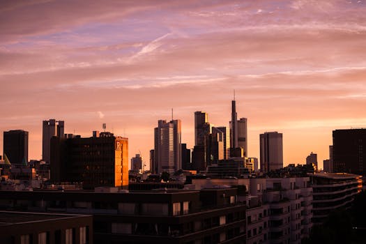 Stunning view of Frankfurt skyline at sunrise with pink and orange hues. Perfect for travel and architecture themes.