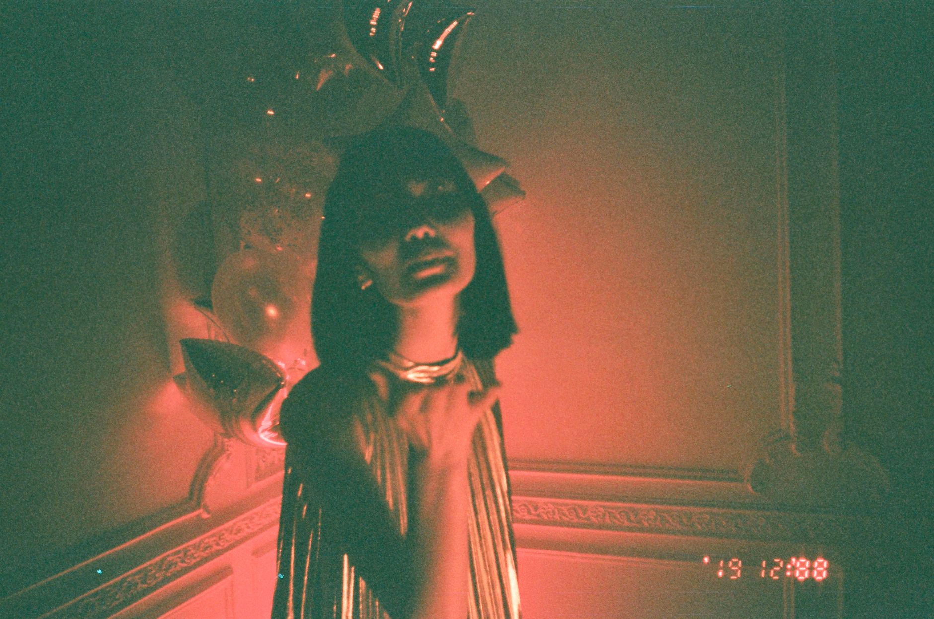 Vintage-lit portrait at a party — the moody, slightly imperfect look a film simulation is trying to recreate
