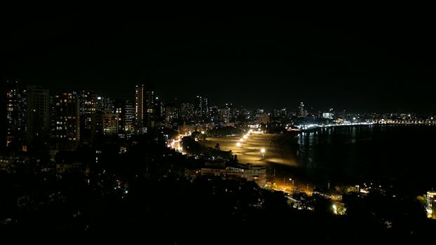 Stunning nighttime landscape of Mumbai's illuminated skyscrapers along Marine Drive.