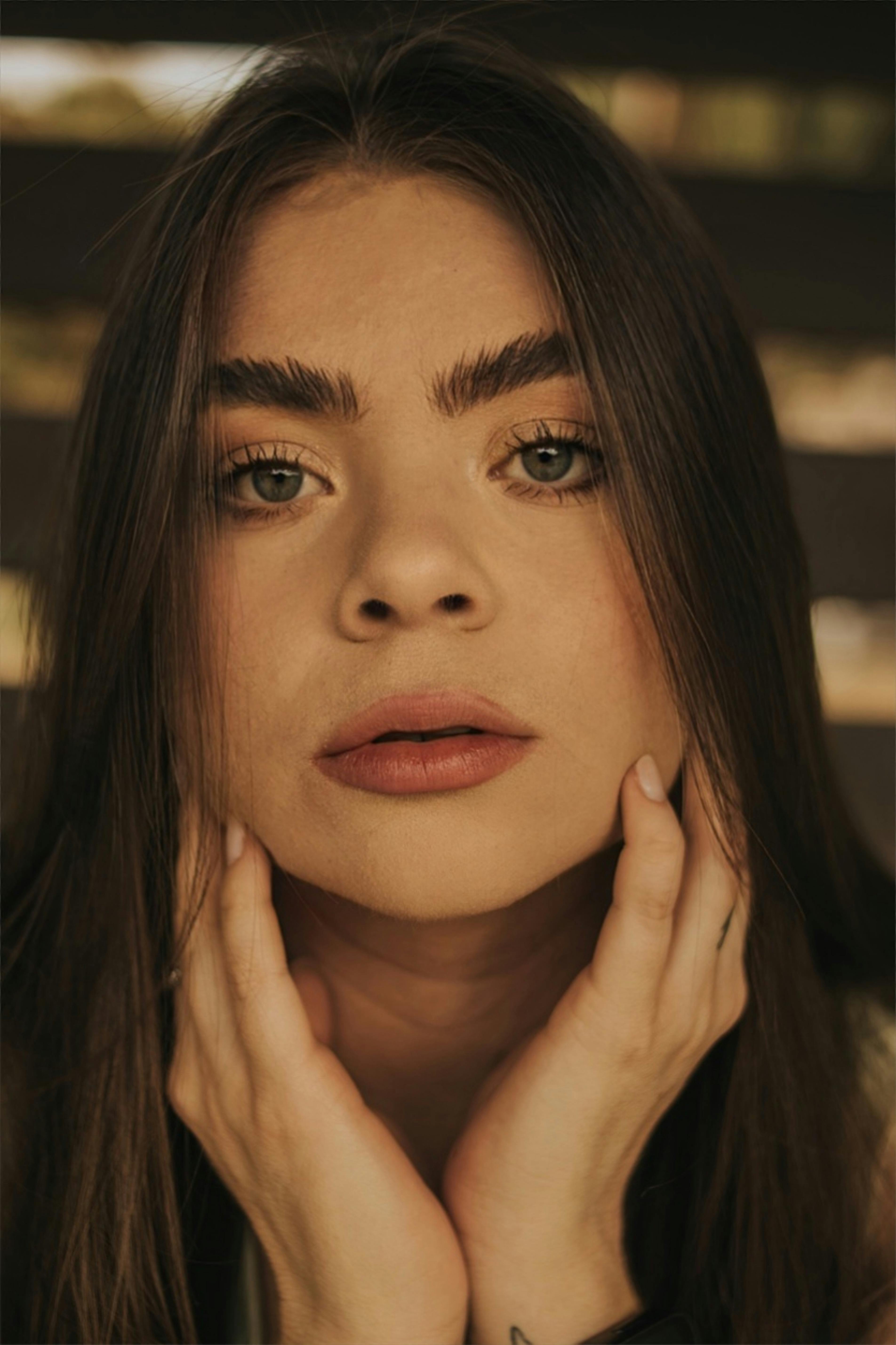 Close-up portrait of a young woman with long hair and expressive eyes.