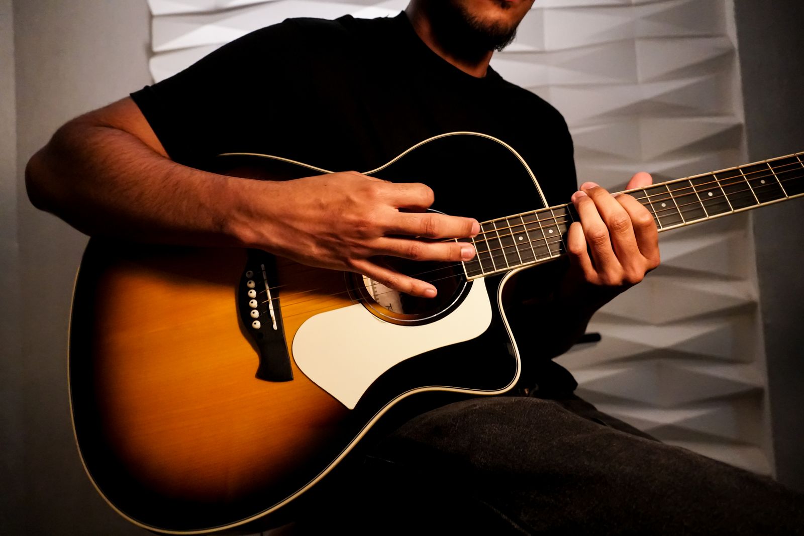 Close-up of hands playing acoustic guitar