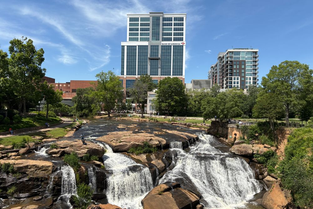 View of downtown Greenville with Reedy River Falls, a unique blend of nature and urban landscape.