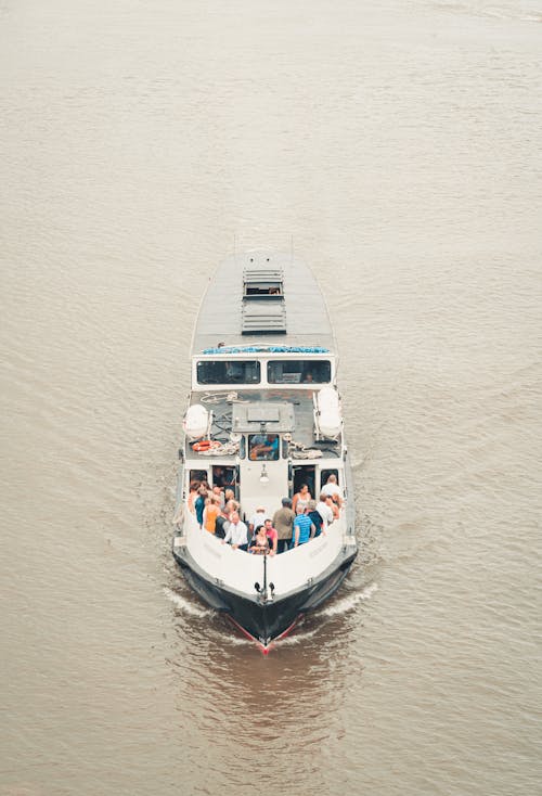 Free Small motorboat with tourists floating on river Stock Photo