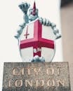 Coat of arms of Knights Templar placed on stone stand with inscription City of London
