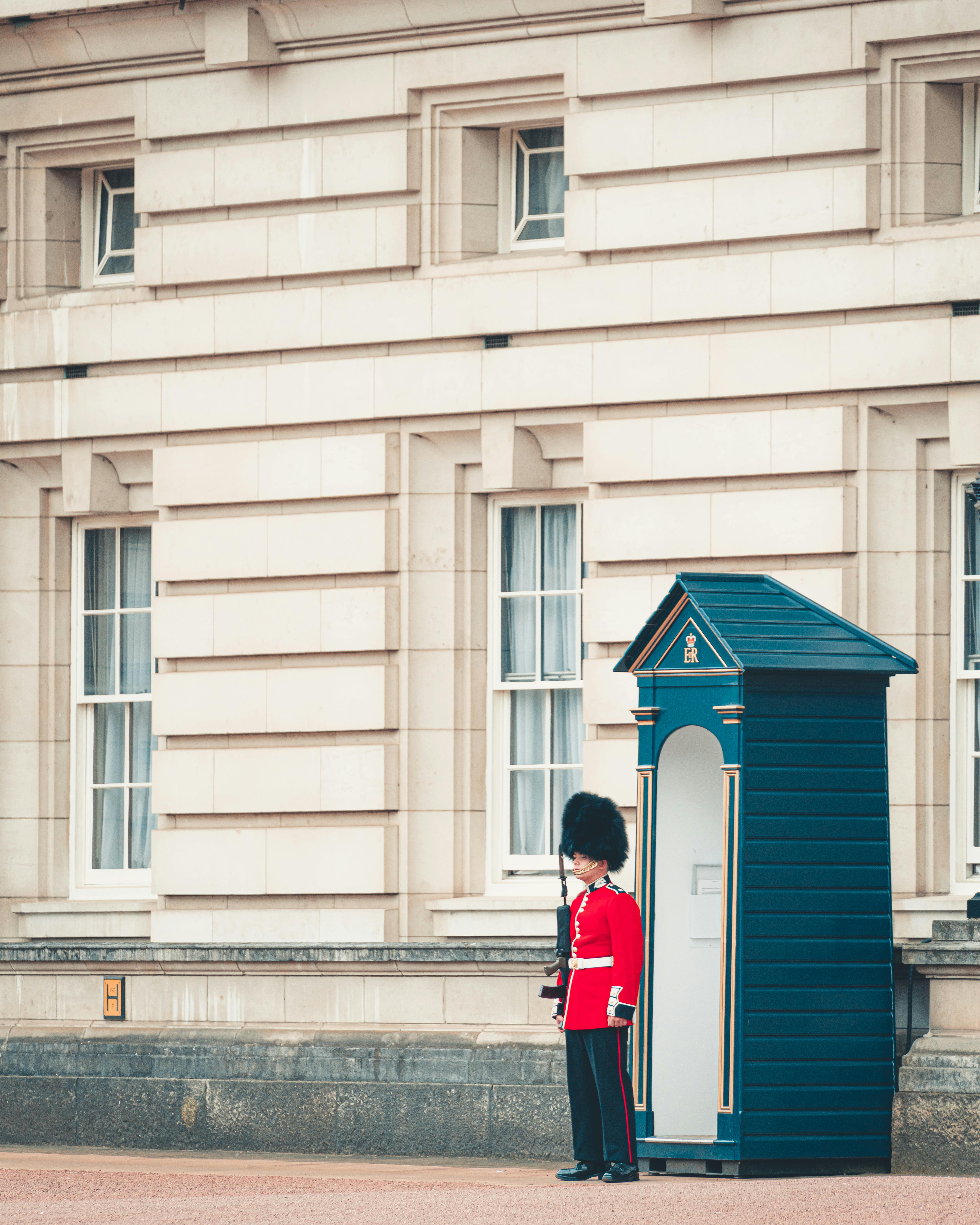 Male Guard Wearing Red and White Costume Holding Rifle ...