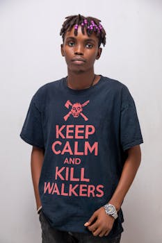 Stylish young adult with colorful hair and graphic tee posing indoors.