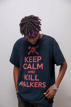 Portrait of an adult wearing a 'Keep Calm and Kill Walkers' T-shirt with a stylish, casual look.