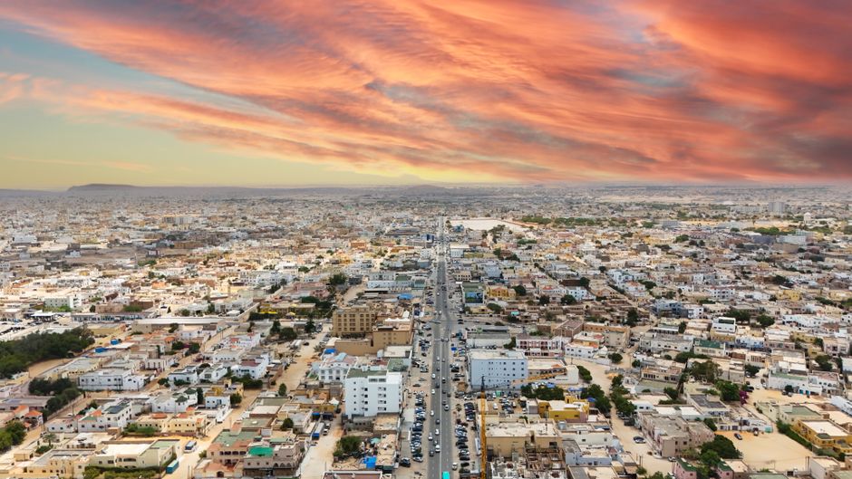 Stunning aerial view of Nouakchott, Mauritania, with vibrant sunset skies and expansive urban landscape.