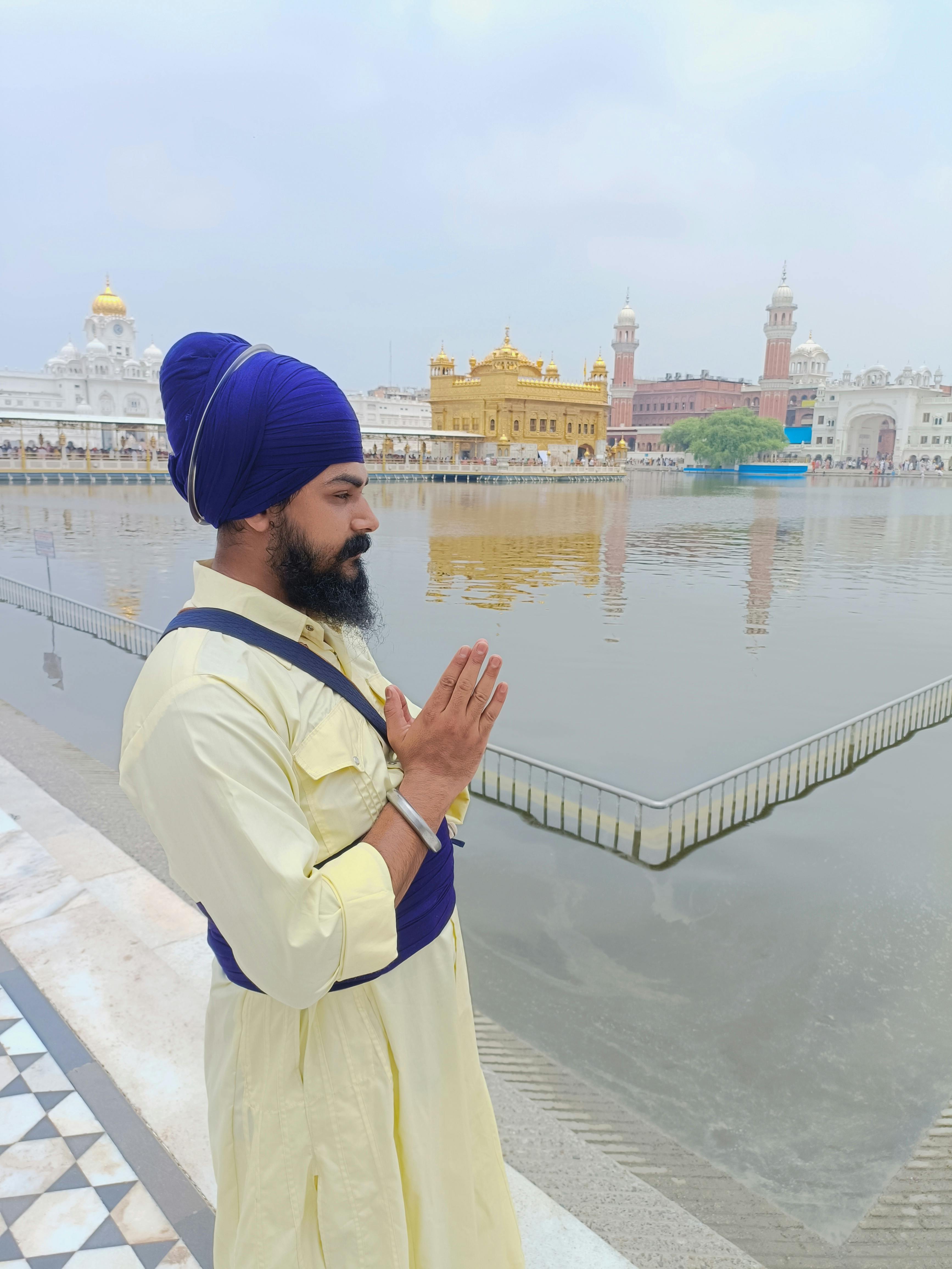 A Sikh man prays by the serene waters at the Golden Temple in Amritsar, India.