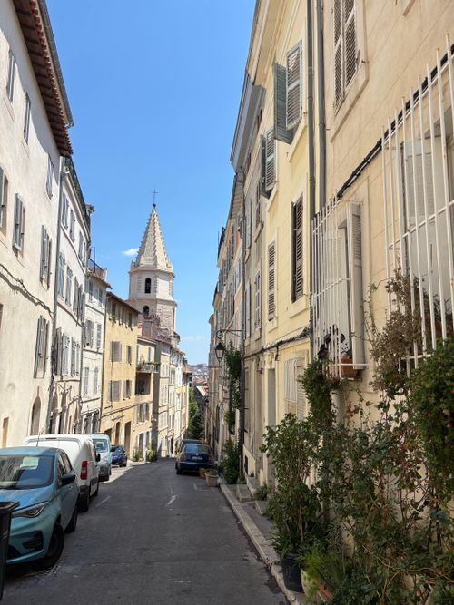 Free Charming narrow street scene in a historic European town with classic architecture. Stock Photo