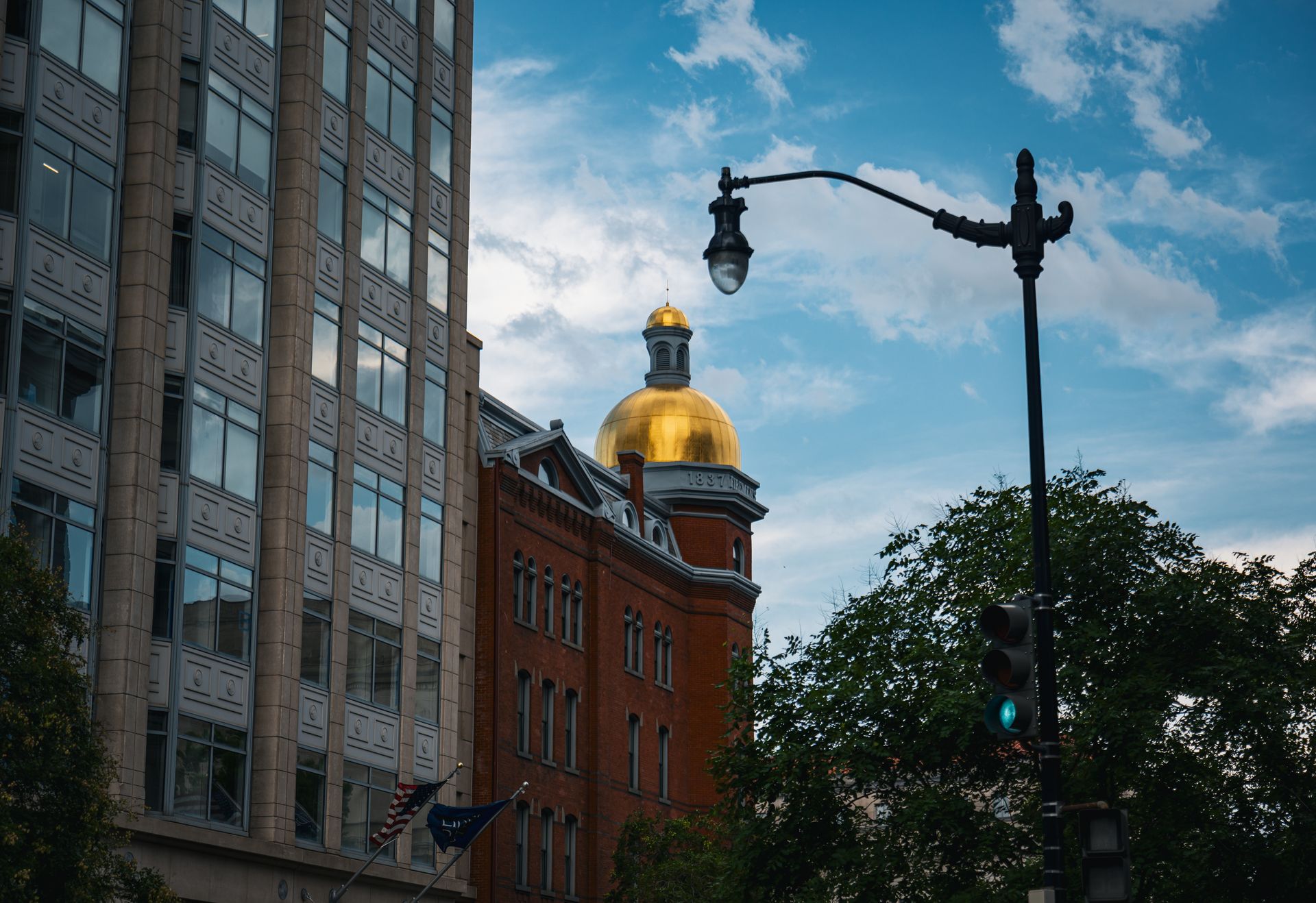 View of golden dome and buildings in Washington D.C. against a blue sky.