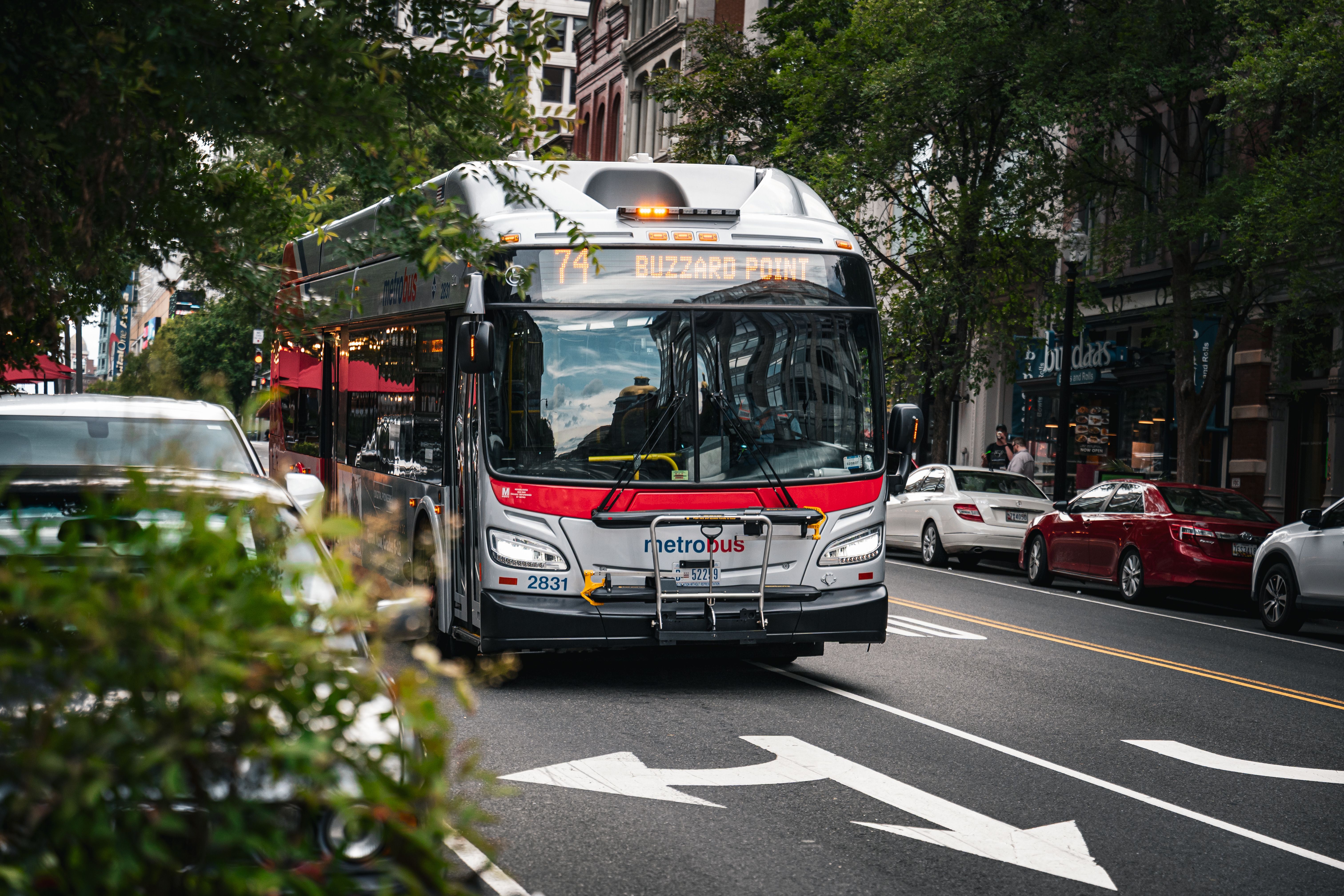 Metrobus driving through Washington D.C., showcasing vibrant city life and urban transportation.