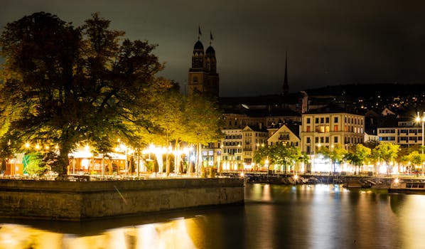 Captivating nighttime view of Zürich's illuminated streets and the iconic Grossmünster.
