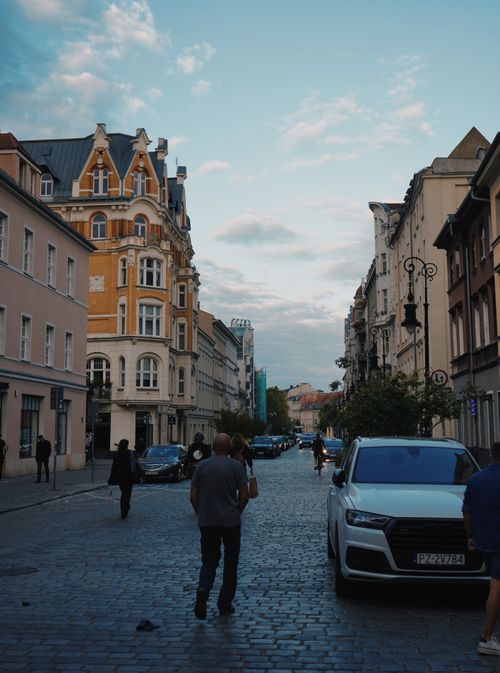 Free A picturesque European street with historic buildings and cobblestone path. Stock Photo