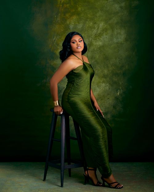 Elegant Woman in Green Dress Against Textured Background Free Stock Photo Elegant Woman in Green Dress Against Textured Background Free Stock Photo