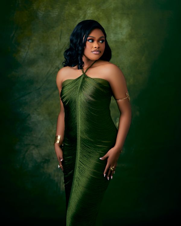 Emerald green velvet dress with gold jewelry