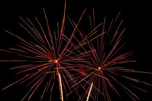 Free Vibrant fireworks burst in the night sky, filling it with colorful streaks of light. Stock Photo
