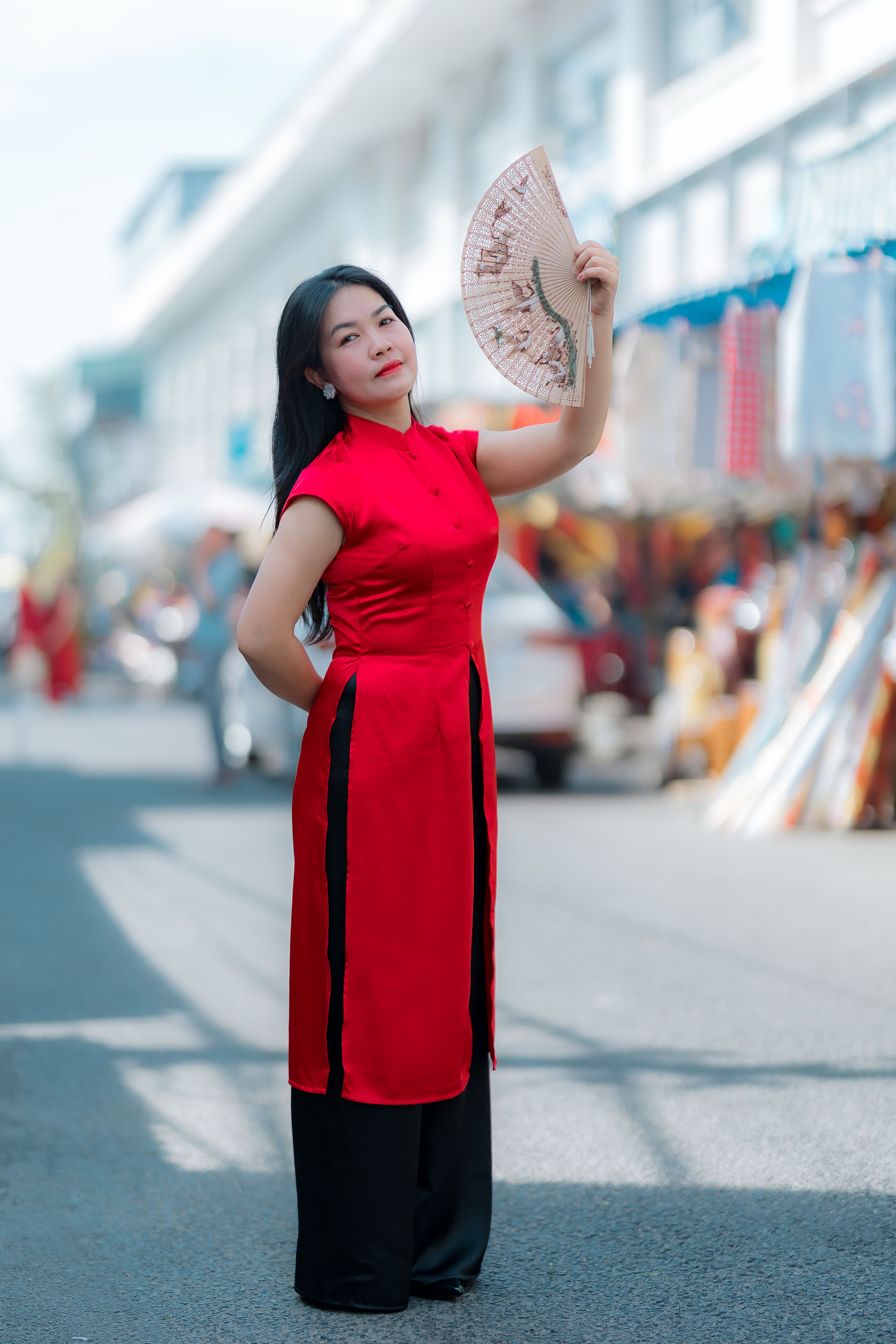 Woman in Traditional Red Dress with Fan Outdoors · Free Stock Photo