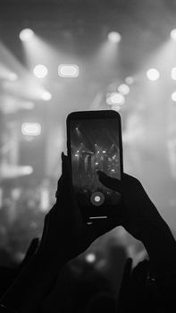 Black and white photo of a concert captured through a smartphone in the Dominican Republic.