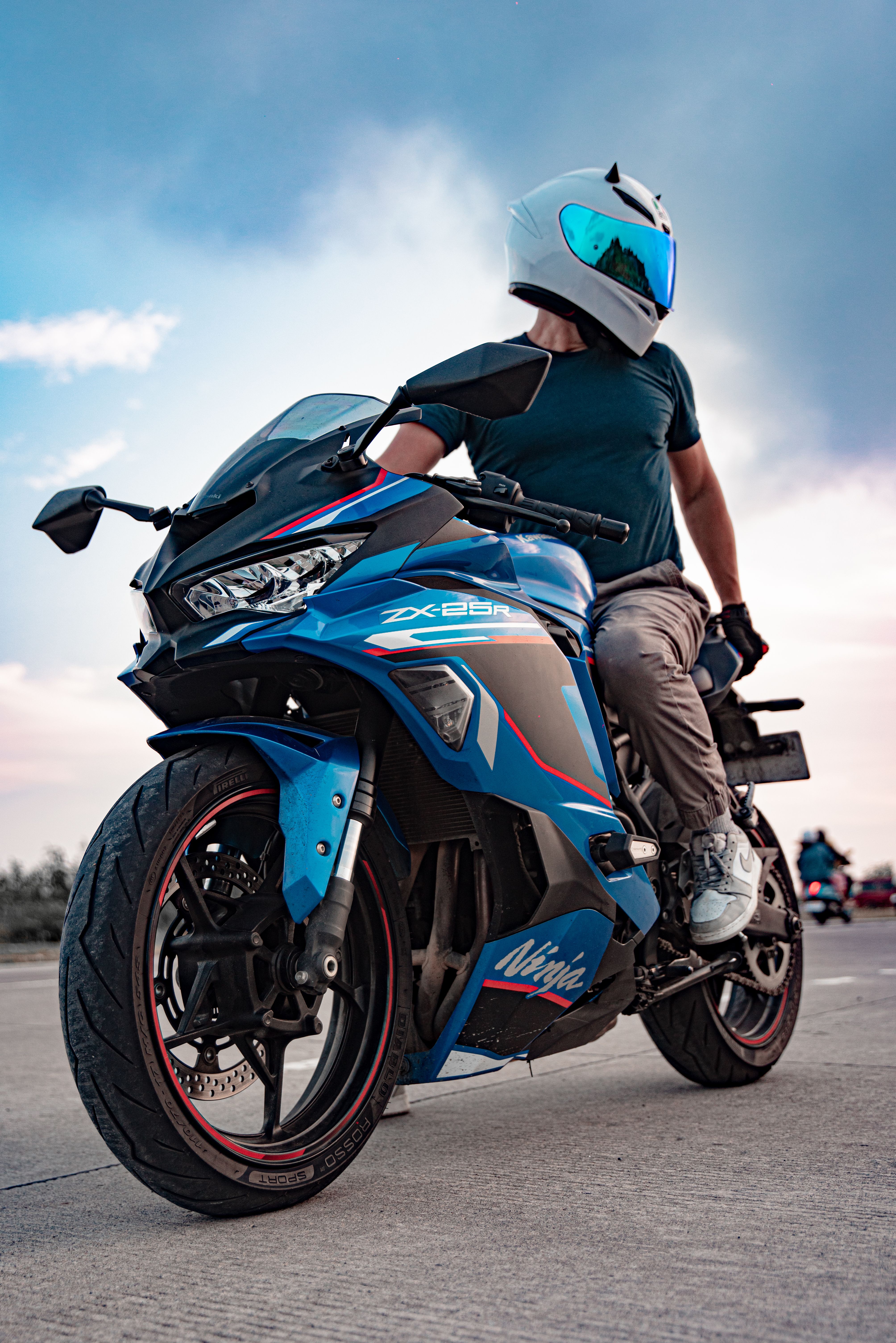 Dynamic shot of a motorcyclist on a blue sport bike during a scenic Bali sunset ride.
