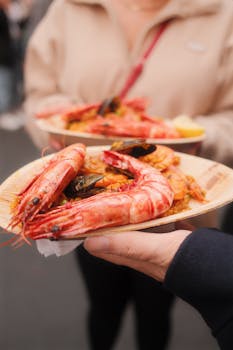 Close-up of vibrant seafood paella with prawns and mussels, perfect for street food enthusiasts.