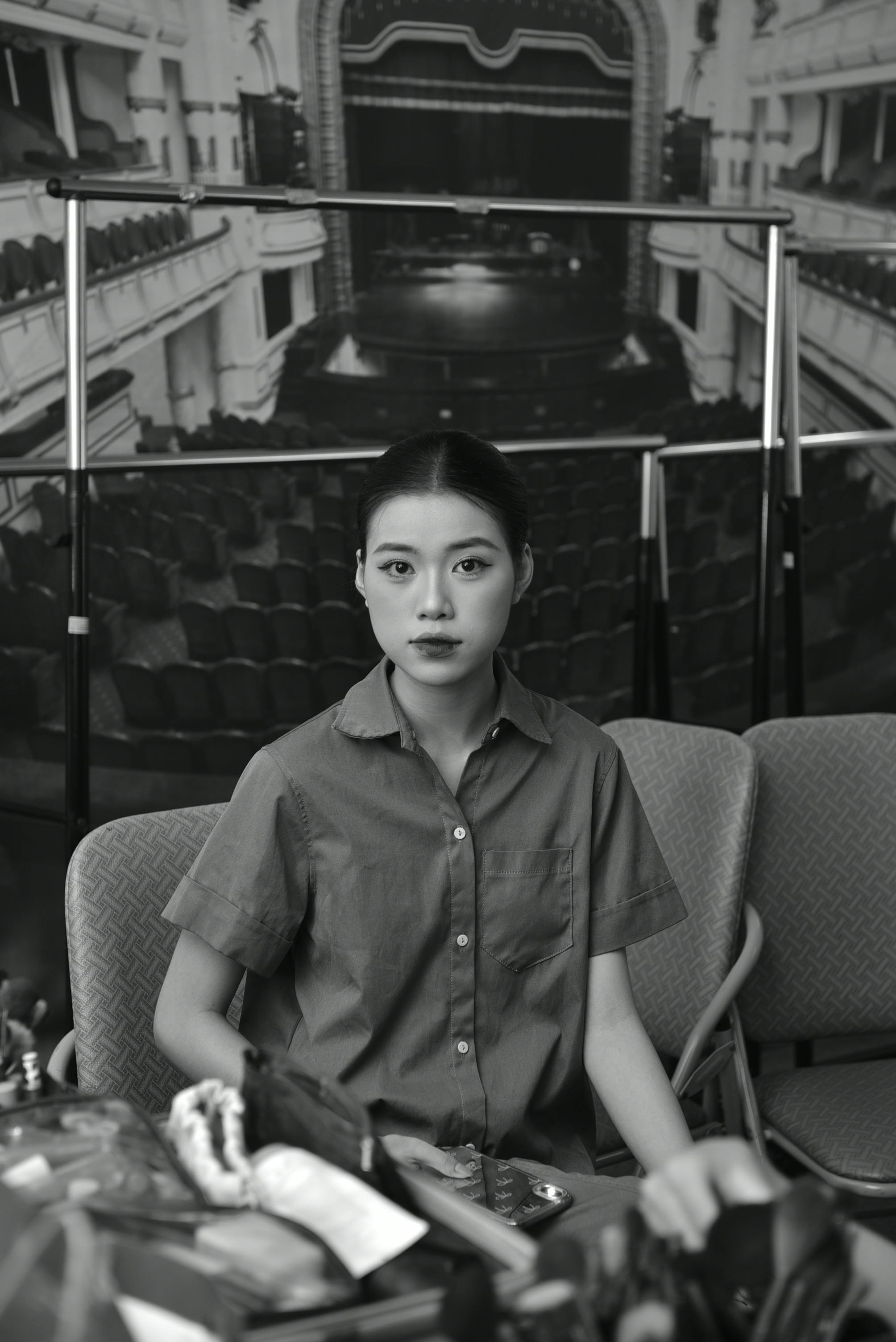 Free Portrait of a woman in front of a vintage theatre backdrop, black and white photo. Stock Photo