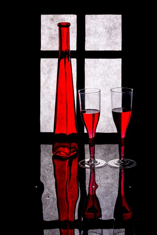 Free Elegant still life of a red bottle and two glasses against a backlit window. Stock Photo